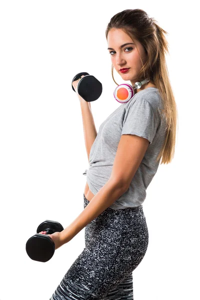 Mujer joven haciendo levantamiento de pesas — Foto de Stock