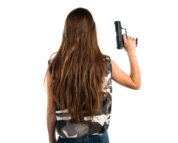 Chica joven sosteniendo una pistola — Foto de Stock