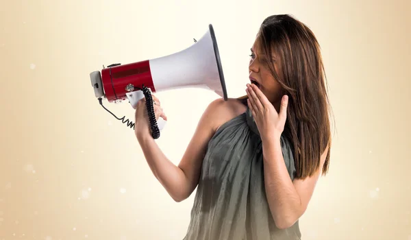 Young girl shouting by megaphone — Stock Photo, Image