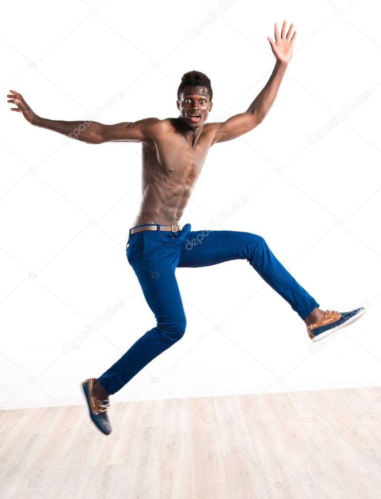 Handsome black man jumping Stock Photo by ©luismolinero 111966526