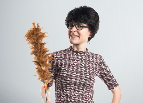 Brunette girl holding a duster