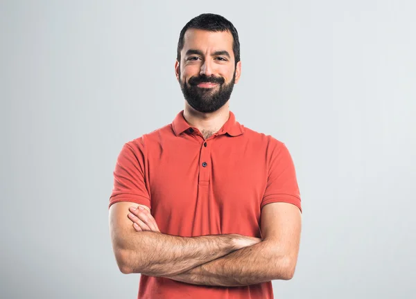 Man wearing red polo shirt with his arms crossed — Stock Photo, Image