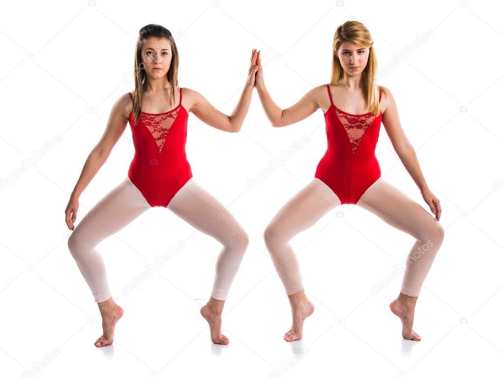 Two girls dancing ballet over isolated background Stock Photo by