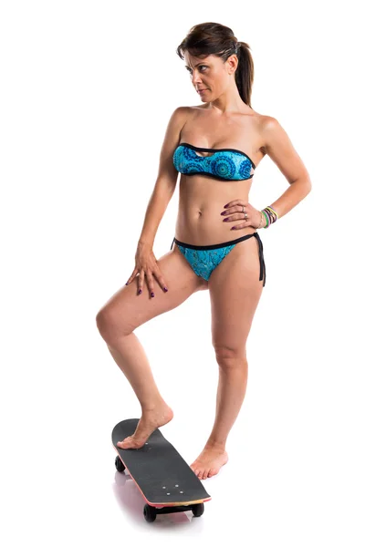 Woman in blue bikini with skate — Stock Photo, Image