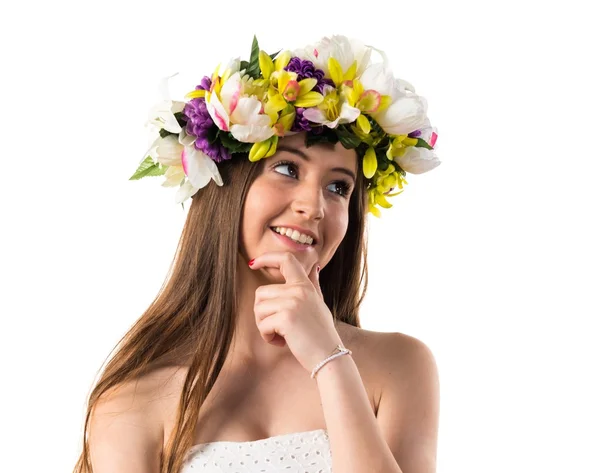 Girl with crown of flowers thinking — Stock Photo, Image