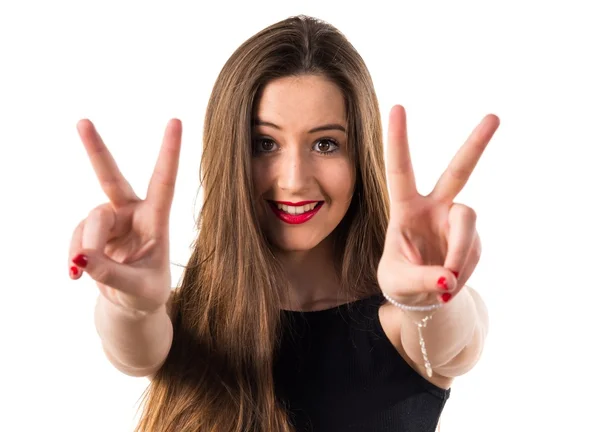 Young girl doing victory gesture — Stock Photo, Image