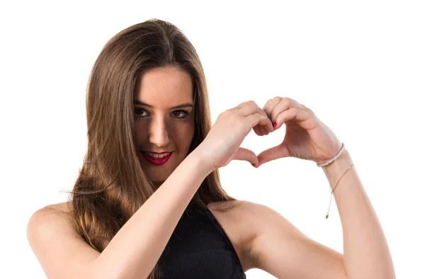 Young girl making a heart with her hands — Stock Photo, Image