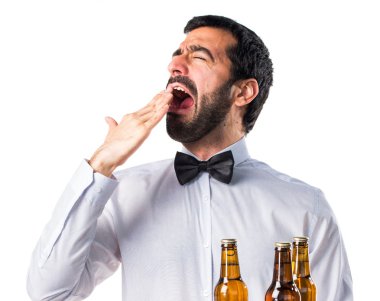 Garson tepsi esneme üzerinde bira şişeleri ile