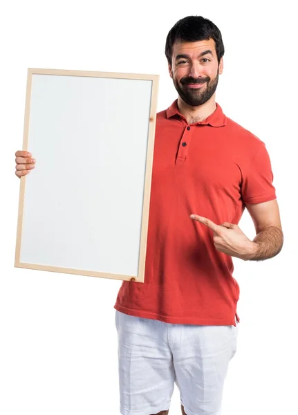 Przystojny mężczyzna trzymając pusty afisz — Zdjęcie stockowe