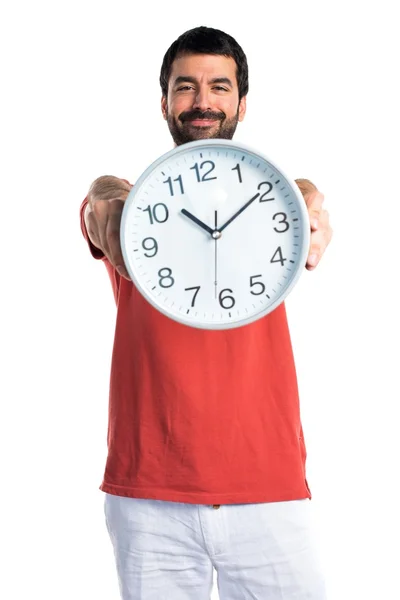 Handsome man holding clock — Stock Photo, Image