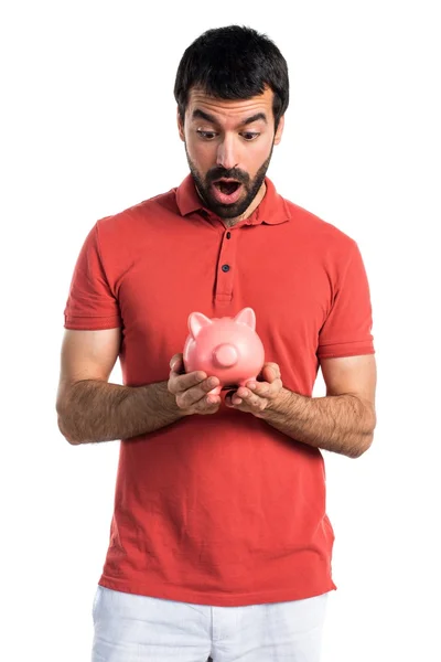 Handsome man holding a piggybank — Stock Photo, Image