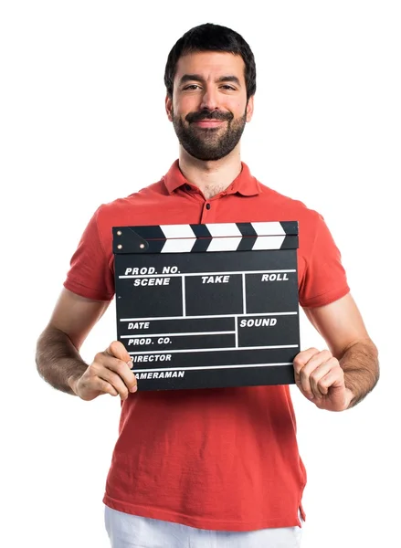 Hombre guapo sosteniendo una tabla de aplausos —  Fotos de Stock