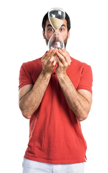 Handsome man holding a vintage sand clock — Stock Photo, Image