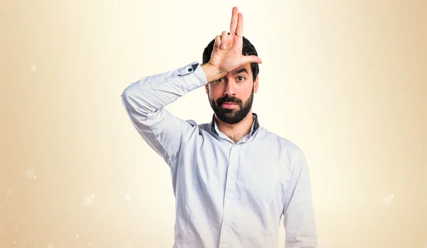 Homem fazendo gesto estúpido — Fotografia de Stock