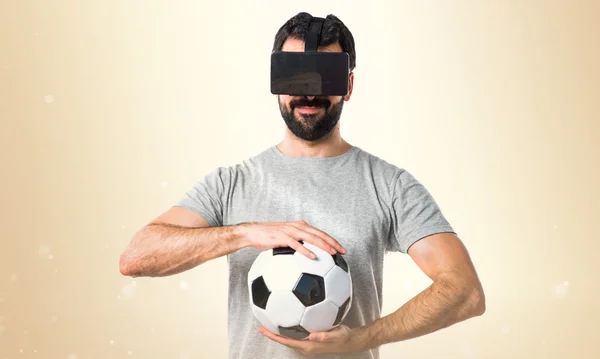 Man playing soccer using VR glasses — Stock Photo, Image