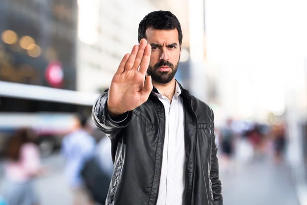 Man with leather jacket making stop sign — Stock Photo, Image