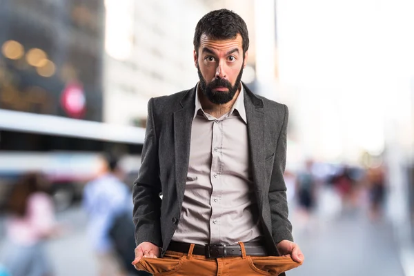 Ruined man looking money in their pockets — Stock Photo, Image