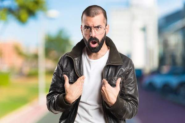 Man wearing a leather jacket doing surprise gesture — Stock Photo, Image