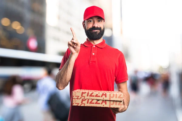 Pizza delivery man pointing up