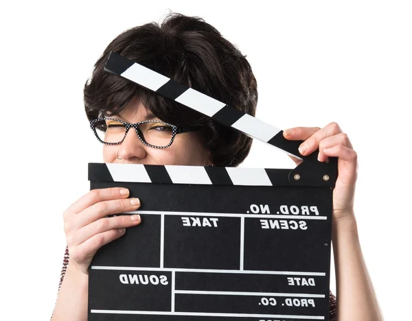 Brunette girl holding a clapperboard — Stock Photo, Image