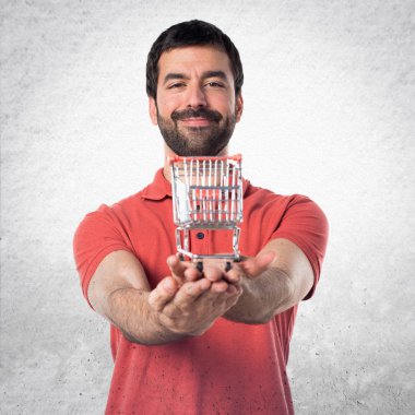 Yakışıklı adam tutmak bir süpermarket arabası oyuncak