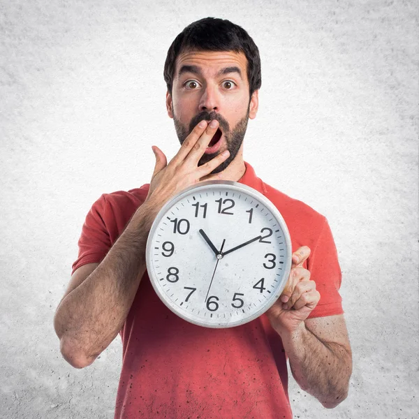 Handsome man holding clock — Stock Photo, Image