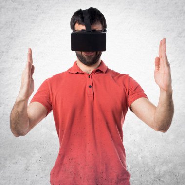 VR glassesa kullanarak ve bir şey tutan yakışıklı adam