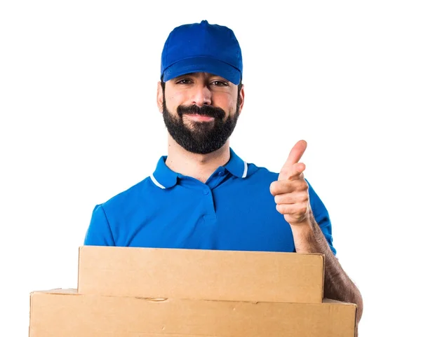 Delivery man pointing to the front — Stock Photo, Image