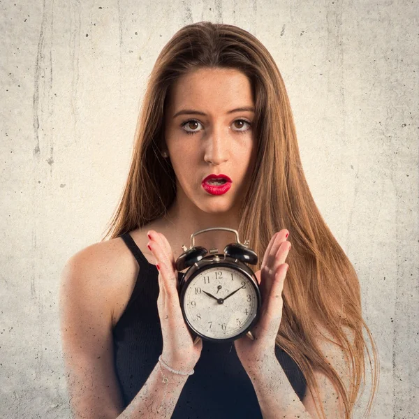 Young girl holding vintage clock — Stock Photo, Image