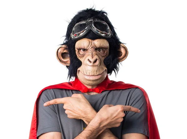 Superhero monkey man pointing to the laterals having doubts — Stock Photo, Image