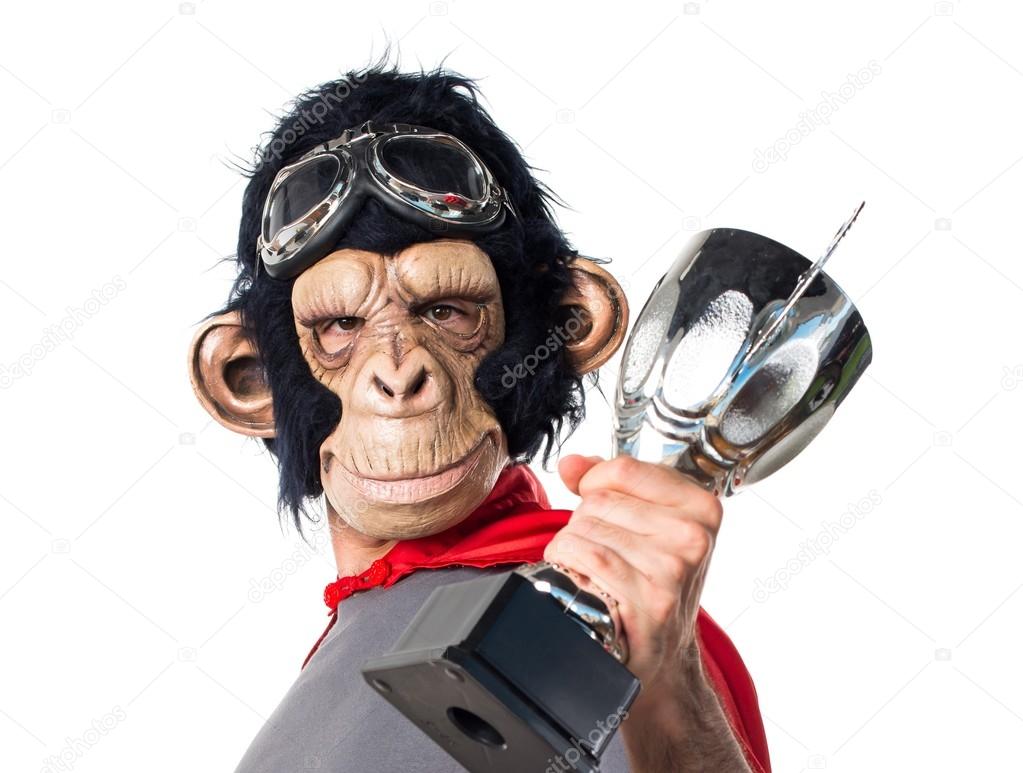 Superhero monkey man holding a trophy