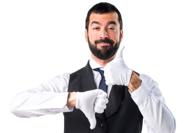 Lüks garson iyi-kötü işaret yapma