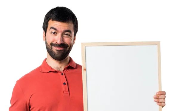 Bonito homem segurando um cartaz vazio — Fotografia de Stock