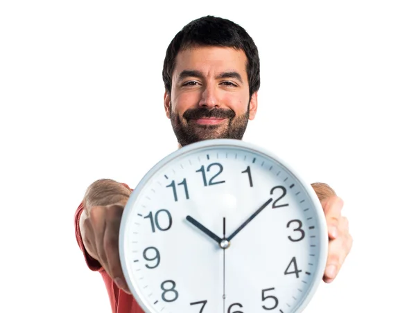 Handsome man holding clock — Stock Photo, Image