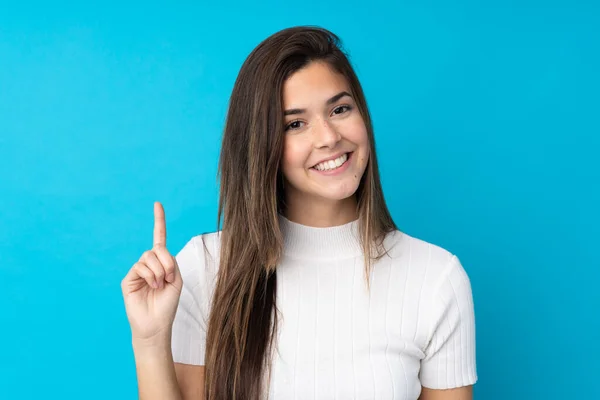 Menina Adolescente Sobre Fundo Azul Isolado Mostrando Levantando Dedo Sinal — Fotografia de Stock