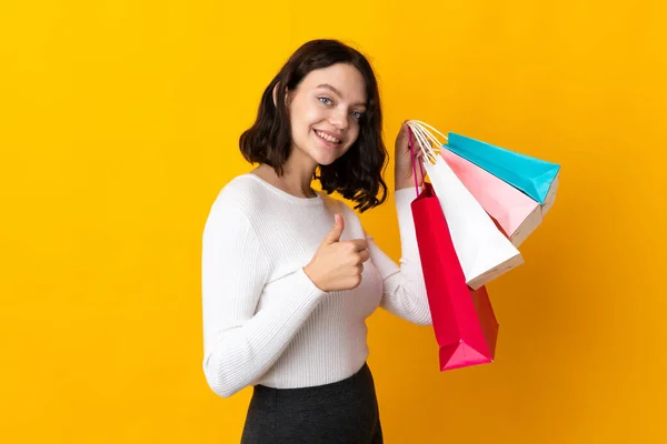 Teenager Ukrainian Girl Isolated Yellow Background Holding Shopping Bags Thumb — Stock Photo, Image