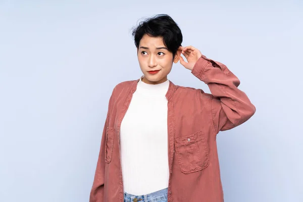 Young Asian Girl Isolated Blue Background Having Doubts — Stock Photo, Image