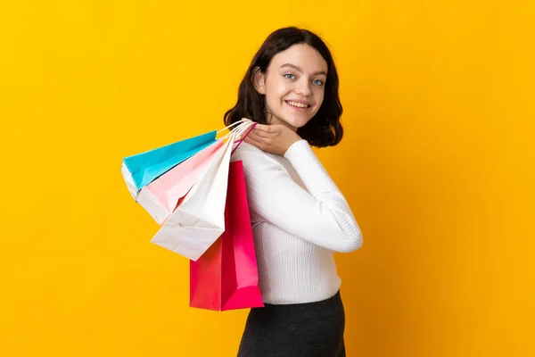 Adolescente Ucraniano Chica Aislado Amarillo Fondo Sosteniendo Bolsas Compras Sonriendo —  Fotos de Stock