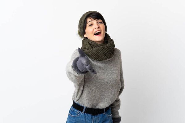Young girl with winter hat shaking hands for closing a good deal