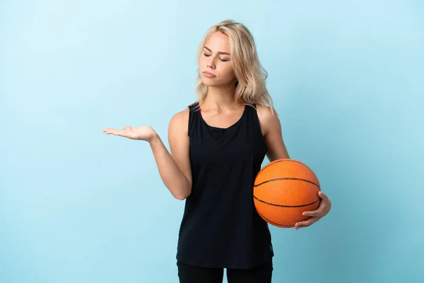 Young Russian Woman Playing Basketball Isolated Blue Background Holding Copyspace — Stock Photo, Image