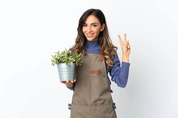 Niña Jardinero Sosteniendo Una Planta Aislada Sobre Fondo Blanco Sonriendo — Foto de Stock