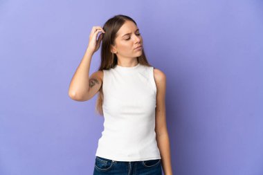 Genç Litvanyalı bir kadın mor arka planda izole edilmiş, kafası kaşınırken şüpheleri var.