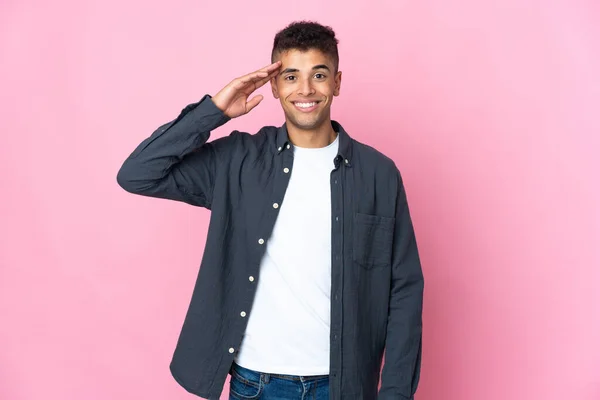 Young Brazilian Man Isolated Pink Background Saluting Hand Happy Expression — Stock Photo, Image