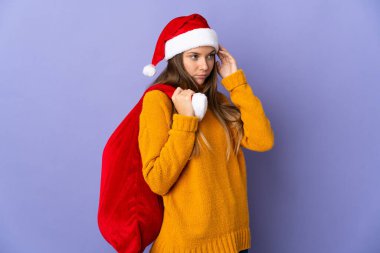 Mor arka planda izole edilmiş yılbaşı şapkalı Litvanyalı kadının şüpheleri ve düşünceleri var.