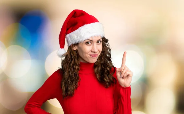 Girl Christmas Hat Pointing Index Finger Great Idea Unfocused Background — ストック写真