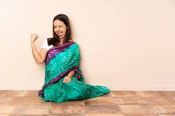 Young Indian Woman Sitting Floor Doing Strong Gesture — Stock Photo, Image