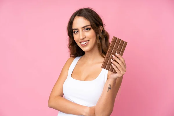 Mladá Žena Nad Izolované Růžové Pozadí Čokoládovou Tabletu Šťastný — Stock fotografie