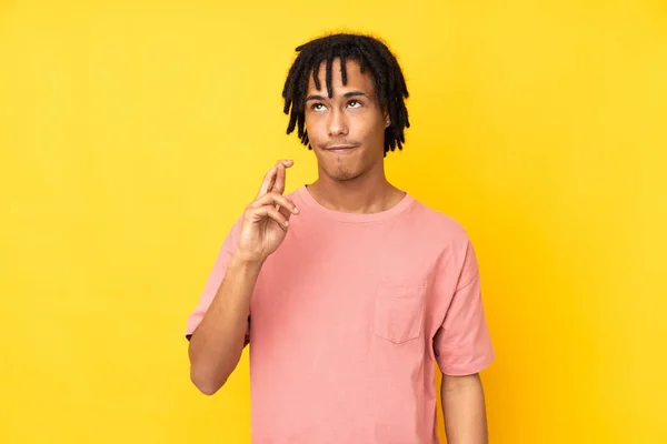 Young African American Man Isolated Yellow Background Fingers Crossing Wishing — Stock Photo, Image