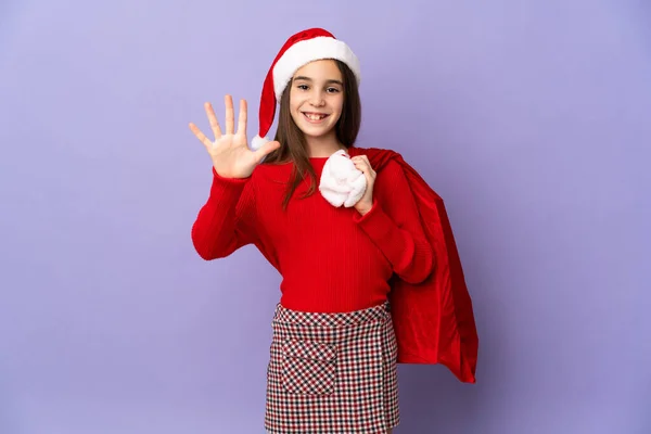 Petite Fille Avec Chapeau Sac Noël Isolé Sur Fond Violet — Photo