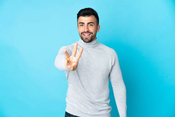 Kavkazský Muž Přes Izolované Modré Pozadí Šťastný Počítání Tři Prsty — Stock fotografie